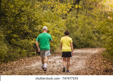 Older man and woman walking energetically on a trail in the fall; Missouri, Midwest - Shutterstock ID 747477193