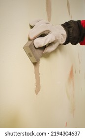 Older Man Working In Empty Apartment Sanding Repair Walls Before Painting