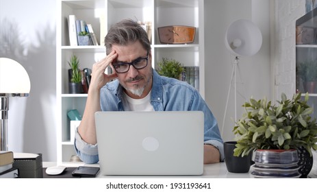 Older Man Working Online With Laptop Computer At Home Sitting At Desk. Home Office, Browsing Internet, Study Room, Entrepreneur.