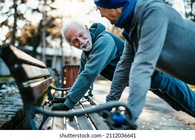 An Older Married Couple Enjoys Exercising And Jogging On A Beautiful Sunny Winter Day.