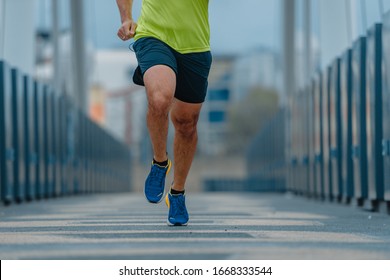 Older mature man in good shape during a running exercise on a bridge - Powered by Shutterstock