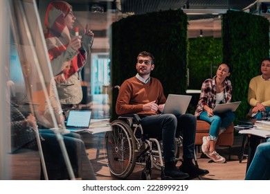 An older Muslim businesswoman presents a project to a young diverse team of people in a modern office - Powered by Shutterstock