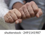 And older newlywed couple showing their wedding rings on their right hand