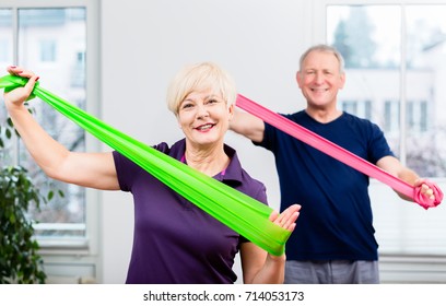 Older patients in physiotherapy using power band for strength training - Powered by Shutterstock