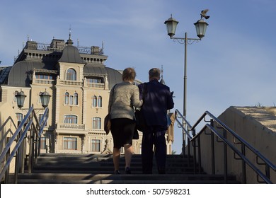 Older People Climb The Stairs To The Building.