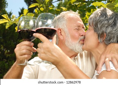 Older people kissing in the garden while on a wine tasting - Powered by Shutterstock