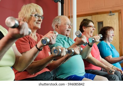 Older People Lifting Weights In Gym