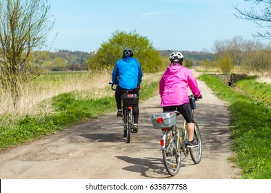 Older People Ride A Bike In The Park