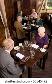 Older Senior Couples Sitting In Smart Restaurant