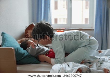 Similar – Relaxed mother and sons playing over the bed