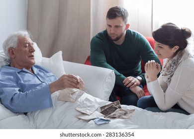 Older Sick Man In Hospital Opening Old Letters