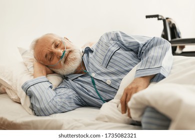 Older Sick Man With A Oxygen Mask Lying In A Hospital Bed