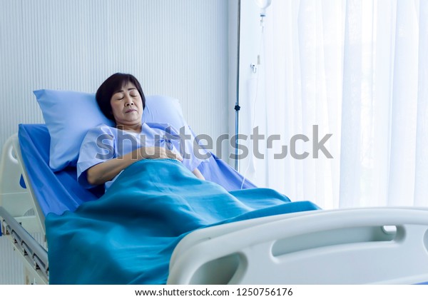 Older Sick Woman Patient Lay On Bed In Hospital With Intravenous Normal Saline Medical 