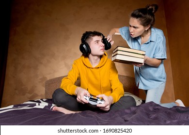 The older sister swears at his brother because of his addiction to computer games. She takes off his headphones and gives books