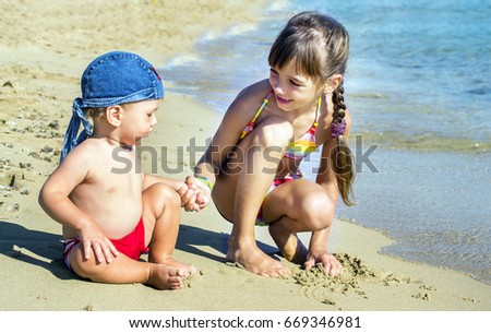 Similar – Two kids digging on the beach