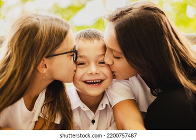 The Older Sisters Kiss Their Younger Brother Who Is Very Happy In First Day Of School.