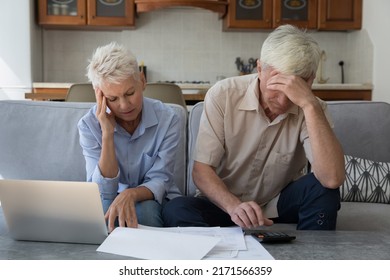Older stressed unhappy wife and husband manage family finances feeling desperate due debts, unpaid bills, lack of money to pay monthly bills or bank mortgage. Financial crisis, bankruptcy concept