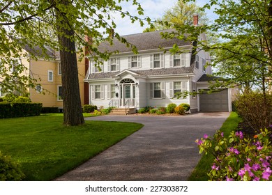 An older style traditional home with a springtime garden.