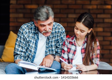 Older Teacher Helping Child To Preparing Before Elementary School.