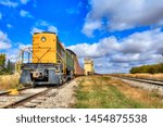 An older train that is stopped at the elevators in Mossleigh, Alberta Canada 