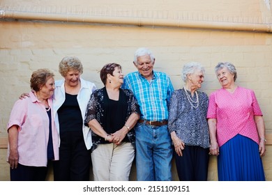 The Older We Get, The More We Enjoy Life. Shot Of A Group Of Seniors Standing Against A Wall Outside.