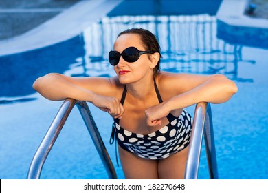 Older Woman 40 50 Years Old In Polka Dot Swimsuit Relaxing At Swimming Pool Or Spa In The Hotel Resort