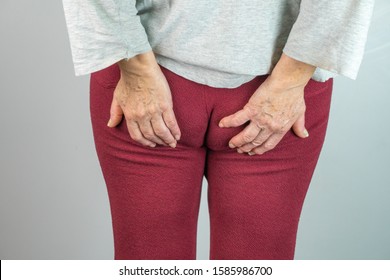 Older Woman From Back With Hands On Buttocks