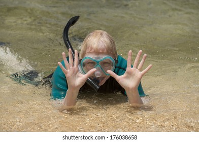 Older Woman At The Beach With Her Snorkel Equipment