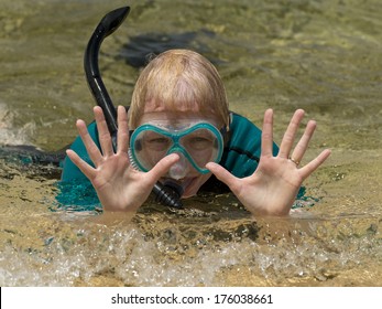 Older Woman At The Beach With Her Snorkel Equipment