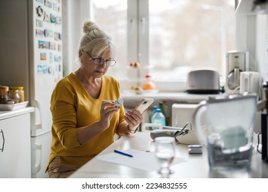 Older woman checking prescription with cell phone
 - Powered by Shutterstock