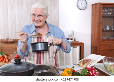 Older Woman Cooking A Meal