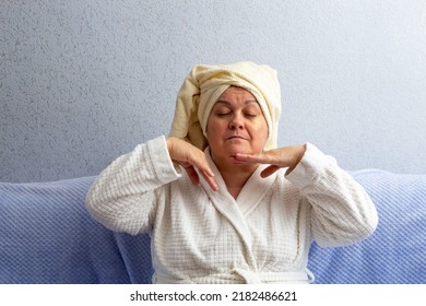 An Older Woman Does An Independent Facial Massage. Patches Are Pasted On The Face. Selective Focus. A Picture For Articles About Age-related Facial Care.
