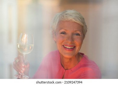 Older Woman Drinking Glass Of White Wine