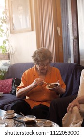 Older Woman Eating With Chocolate Cake.