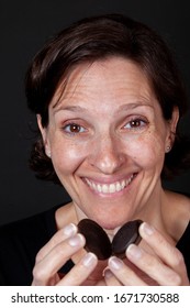 Older Woman Eating A Chocolate Cream Filled Cookie. Unhealthy Lifestyle Junk Food Concept.