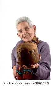 Older Woman Eating Panettone On White Background