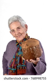 Older Woman Eating Panettone On White Background