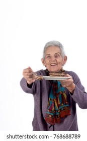 Older Woman Eating A Piece Of Cake