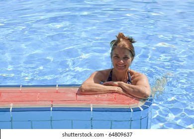 An Older Woman Enjoying The Swimming Pool