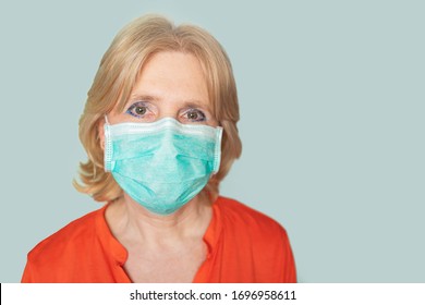 Older Woman With Face Mask Looking Directly In Camera  