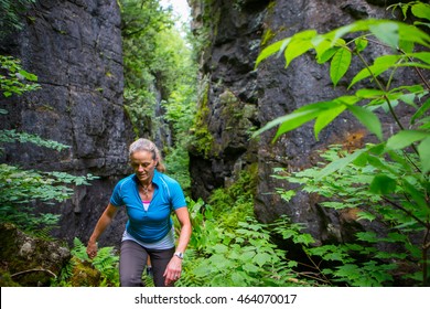 Older Woman Hiking In The Forest