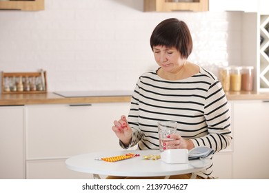 Older Woman Hold Glass Of Water And Antibiotic Aspirin Pill Feel Unhealthy At Home, Sick Mature Female Take Daily Dose Of Supplements Or Vitamins, Elderly Healthcare Concept.