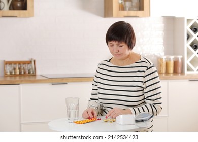 Older Woman Hold Glass Of Water And Antibiotic Aspirin Pill Feel Unhealthy At Home, Sick Mature Female Take Daily Dose Of Supplements Or Vitamins, Elderly Healthcare Concept.