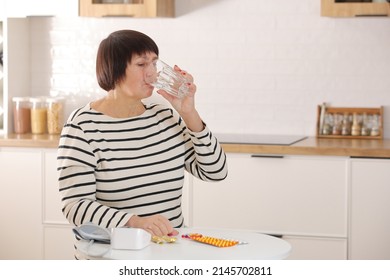 Older Woman Hold Glass Of Water And Antibiotic Aspirin Pill Feel Unhealthy At Home, Sick Mature Female Take Daily Dose Of Supplements Or Vitamins, Elderly Healthcare Concept.