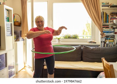 Older Woman Hula Hooping At Home
