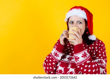 Older Woman Laying Down With A Traditional Christmas Mug. Santa Claus Hat