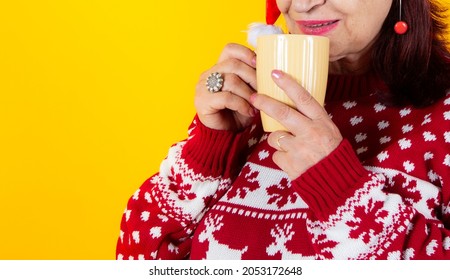 Older Woman Laying Down With A Traditional Christmas Mug. Santa Claus Hat