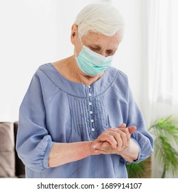 Older Woman With Medical Mask Praying 