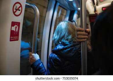 Older Woman In Modern Subway Train To City On Travel Lifestyle