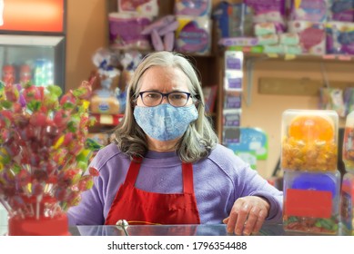 
Older Woman Owner Of Small Grocery Store, Wearing Face Protecti